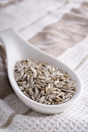 Pumpkin seeds in a white serving spoon