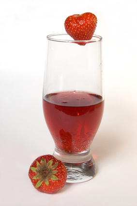 Red champagne with strawberries, isolated on white